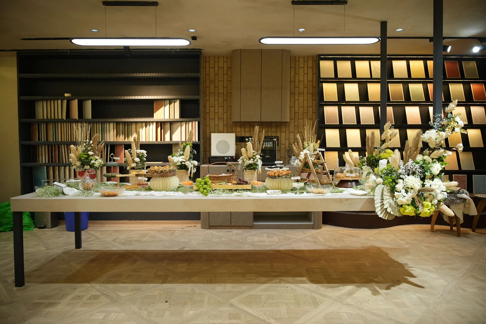 The full grazing table at Soul Studio, with pale linen, flowers and tiered serving stands.